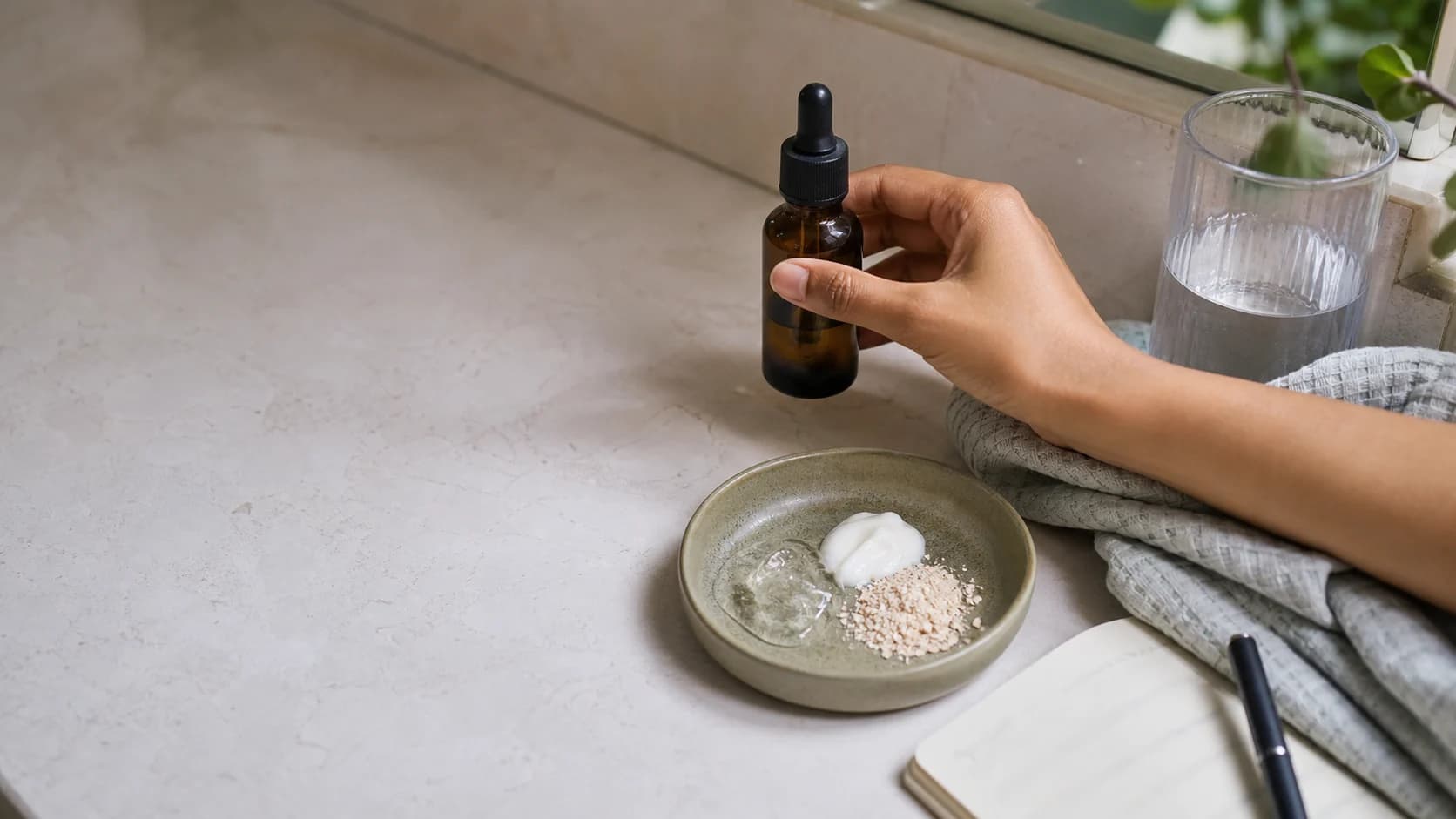 Unbranded amber dropper and familiar cosmetic textures on a real bathroom vanity